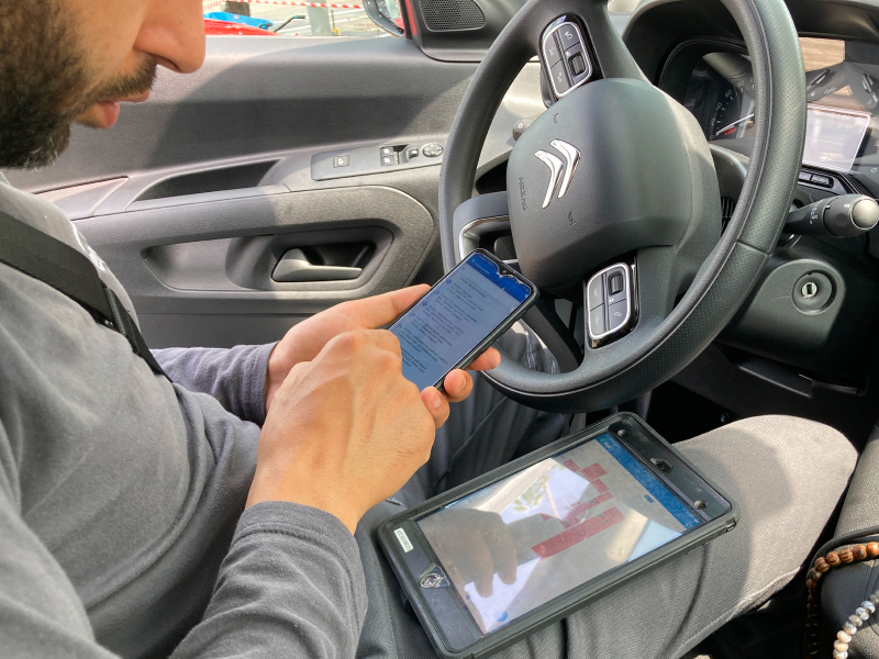 User research observation, technician using tablet phone in car